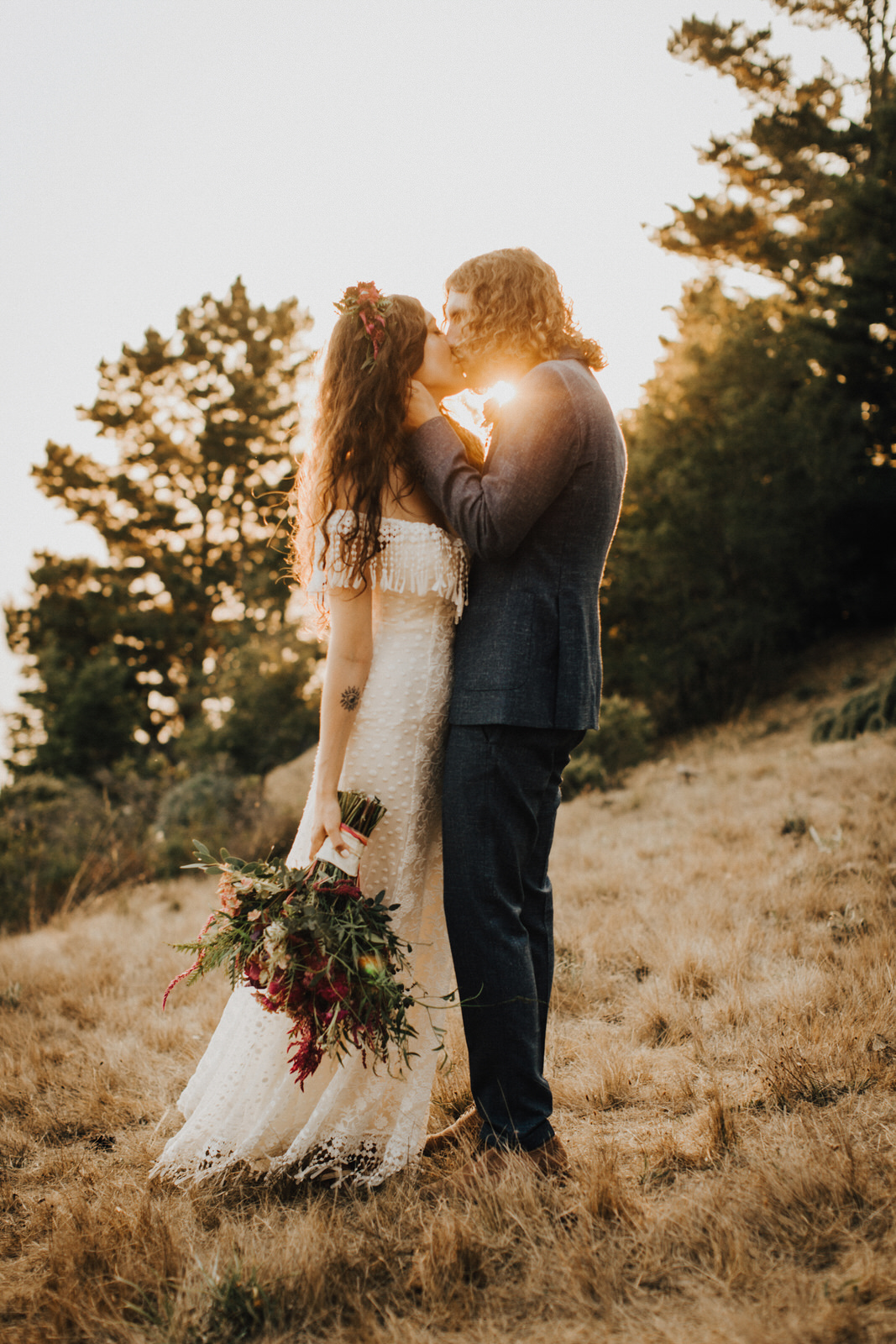 Wedding couple kissing at sunset