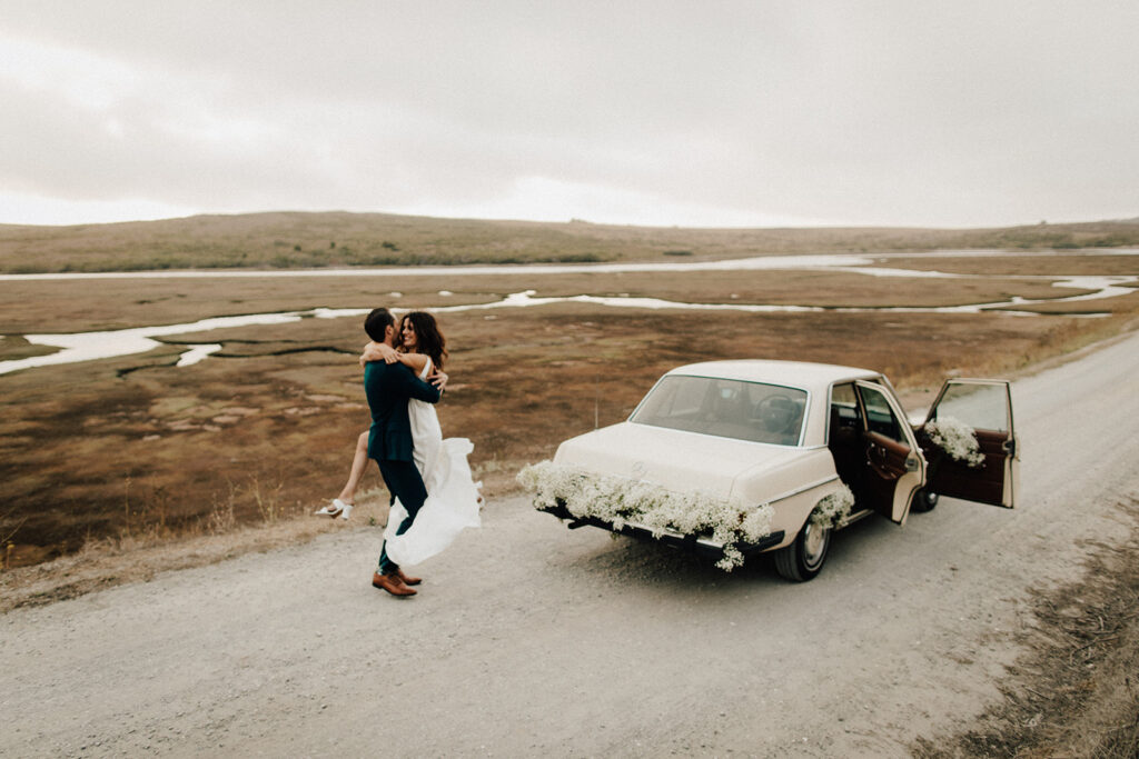 Couple with getaway car after Point Reyes elopement