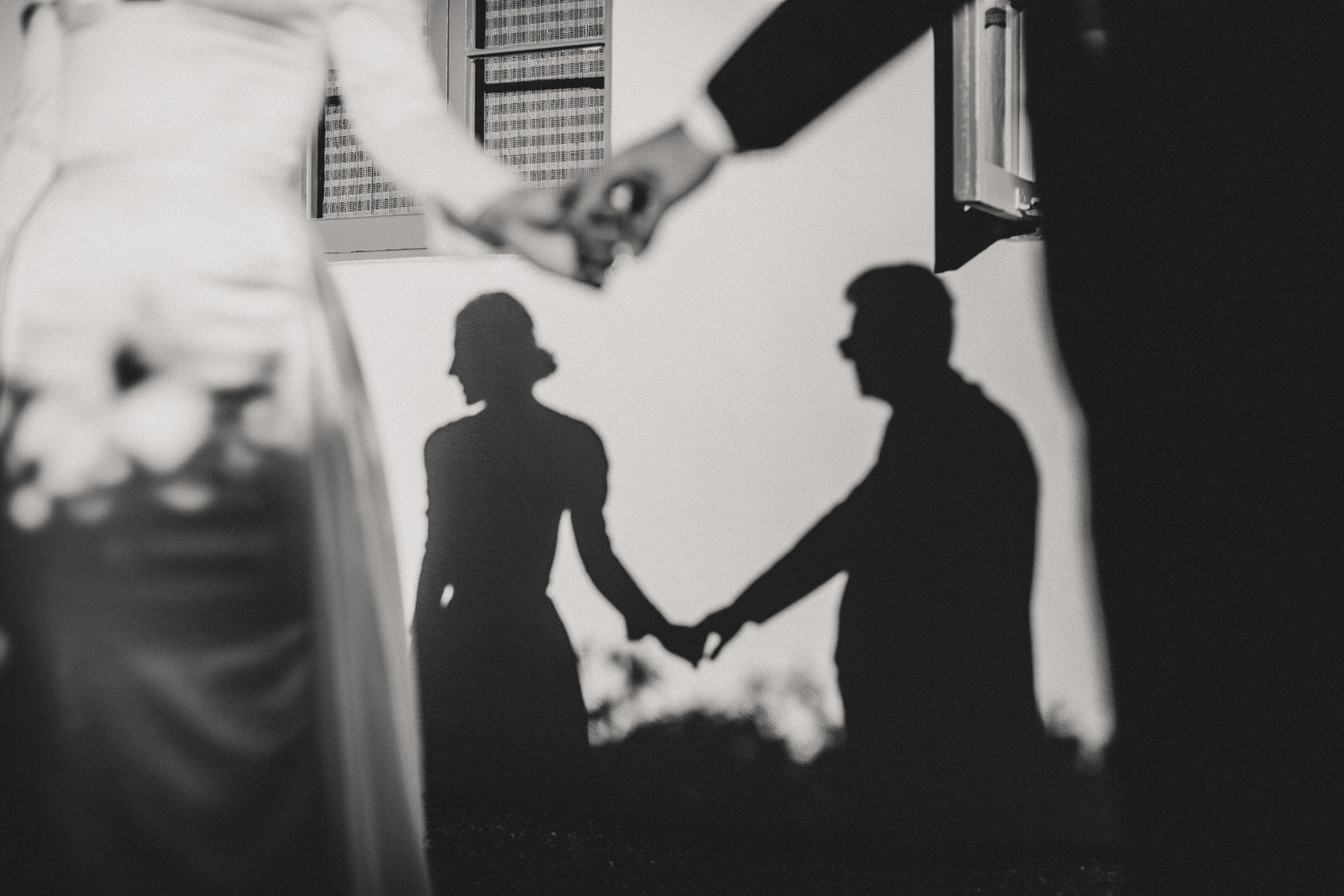 Black and white image of a couple holding hands