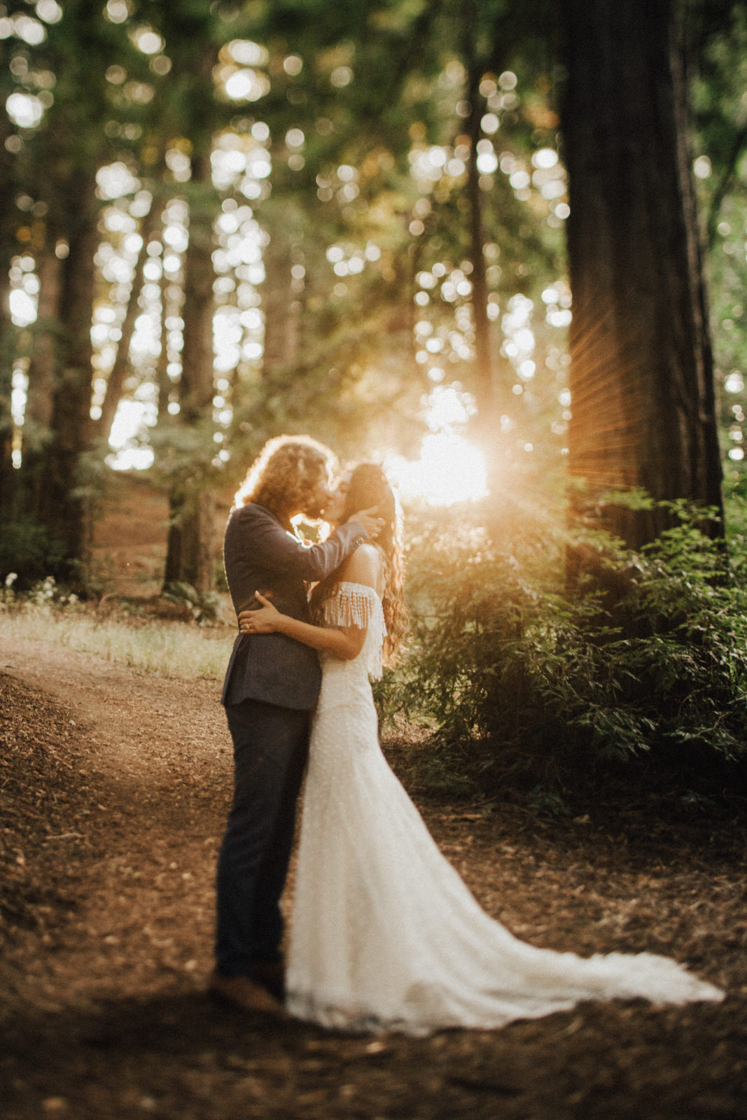 Couple kissing in the forest at Post Ranch