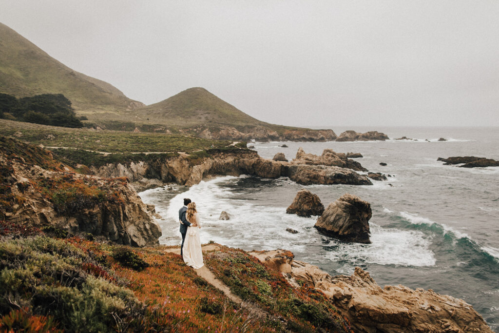 Bride and groom take in the view in Garrapata State Park after elopement