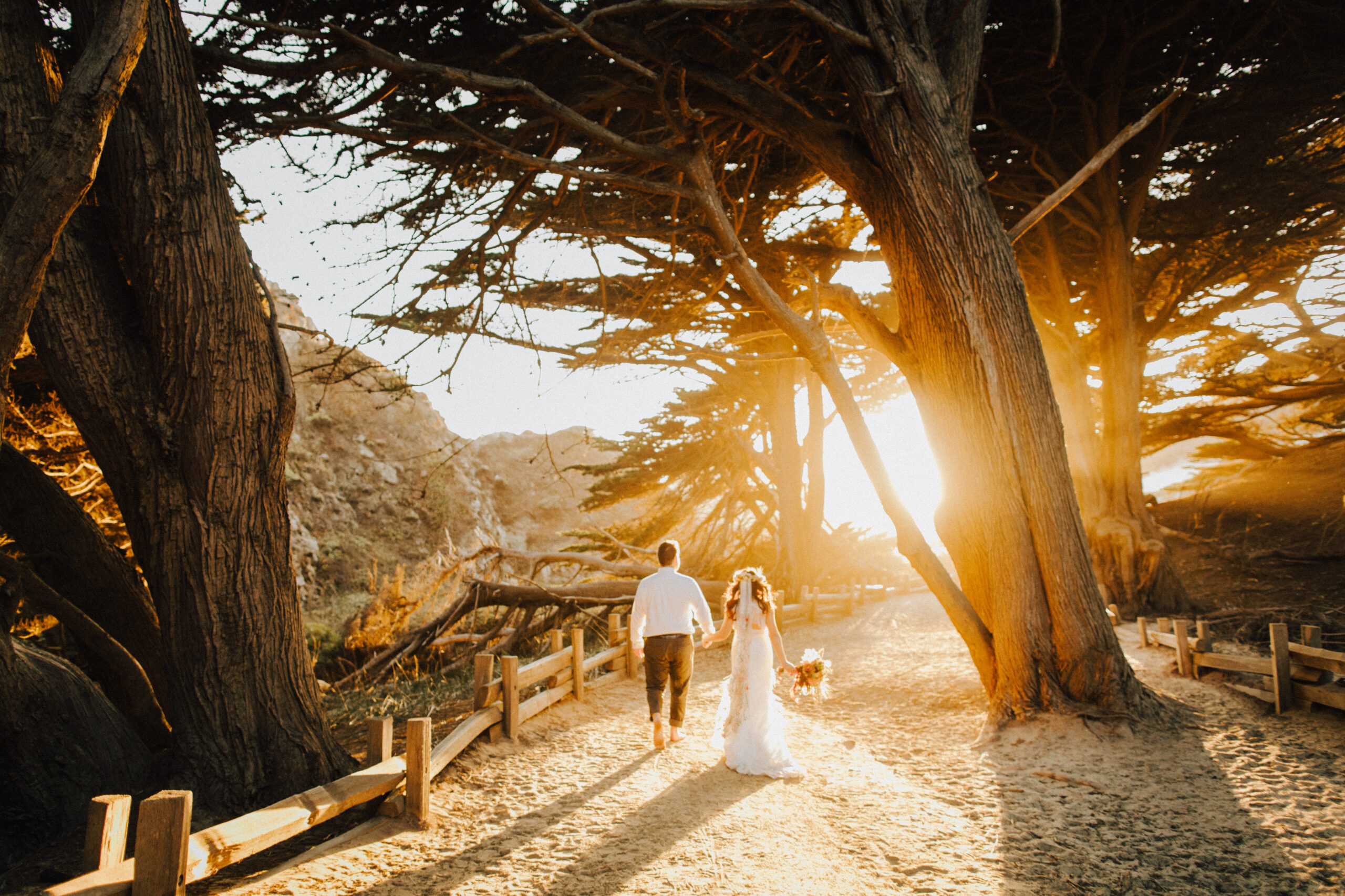 Golden light with couple walking to Pfeiffer beach