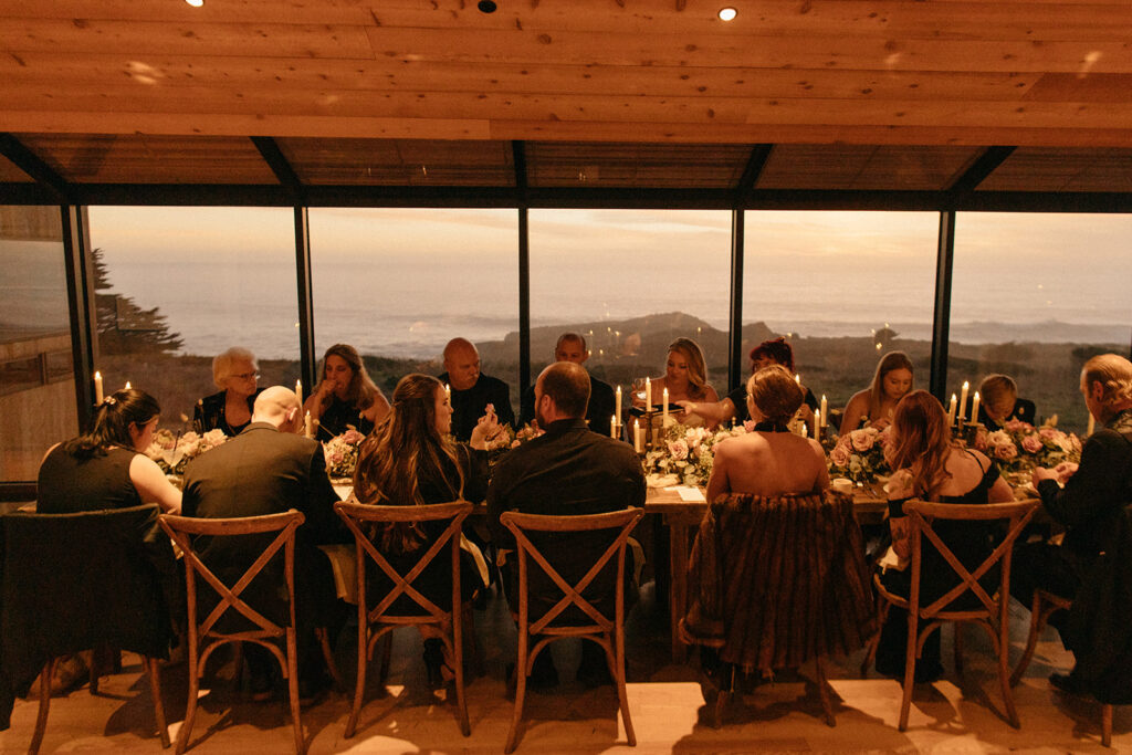 Bride and groom eat with their guests in The Sea Ranch Lodge